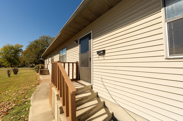 view of side of property with a lawn