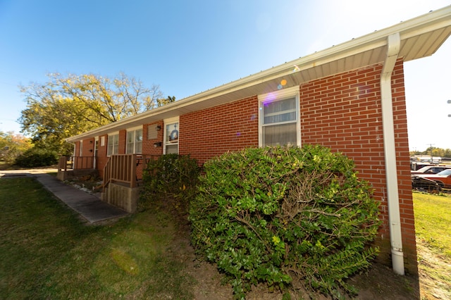 view of property exterior with a lawn