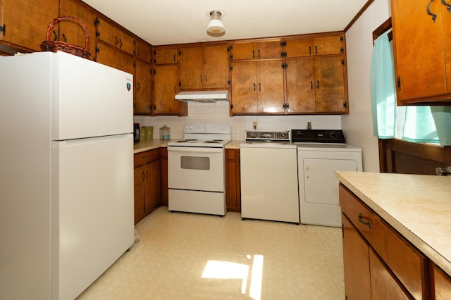 kitchen with independent washer and dryer, white appliances, and backsplash