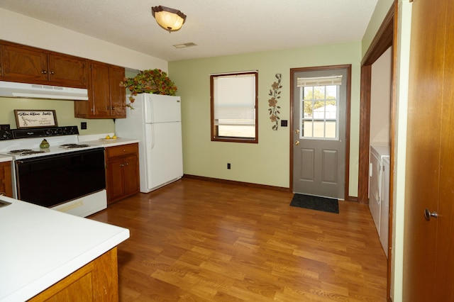 kitchen featuring light hardwood / wood-style floors and white appliances