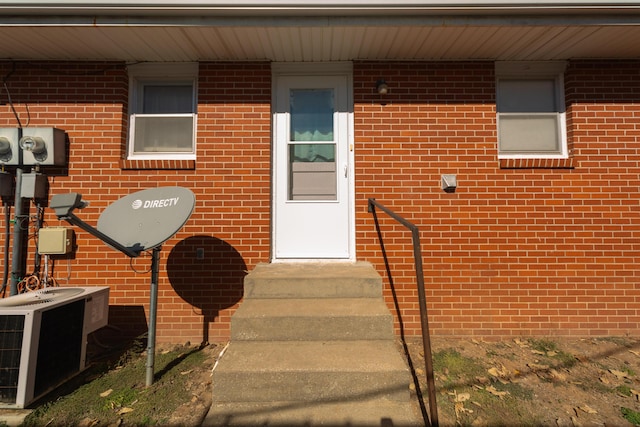 view of exterior entry with central AC unit