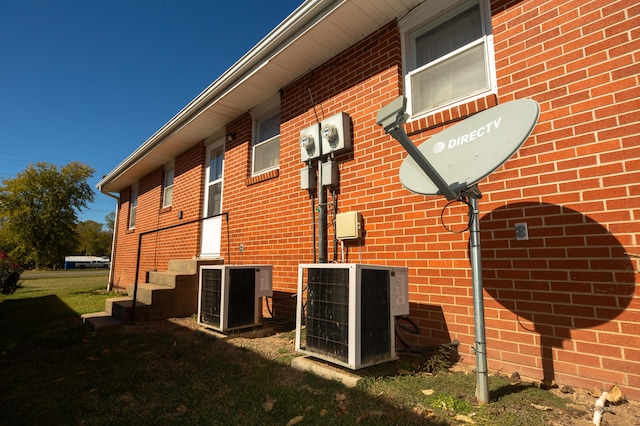 view of side of home featuring central AC