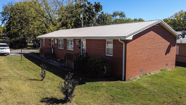 view of property exterior with a yard