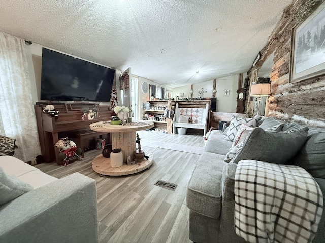 living room featuring hardwood / wood-style flooring and a textured ceiling