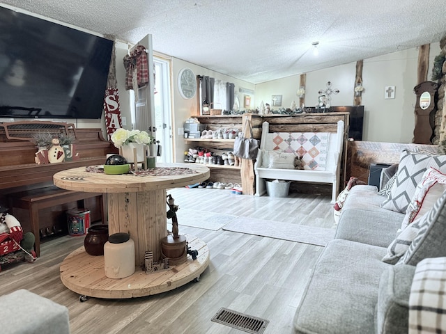 living room with hardwood / wood-style flooring and a textured ceiling