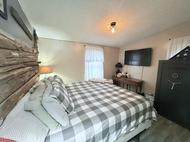 bedroom with wood-type flooring and a textured ceiling