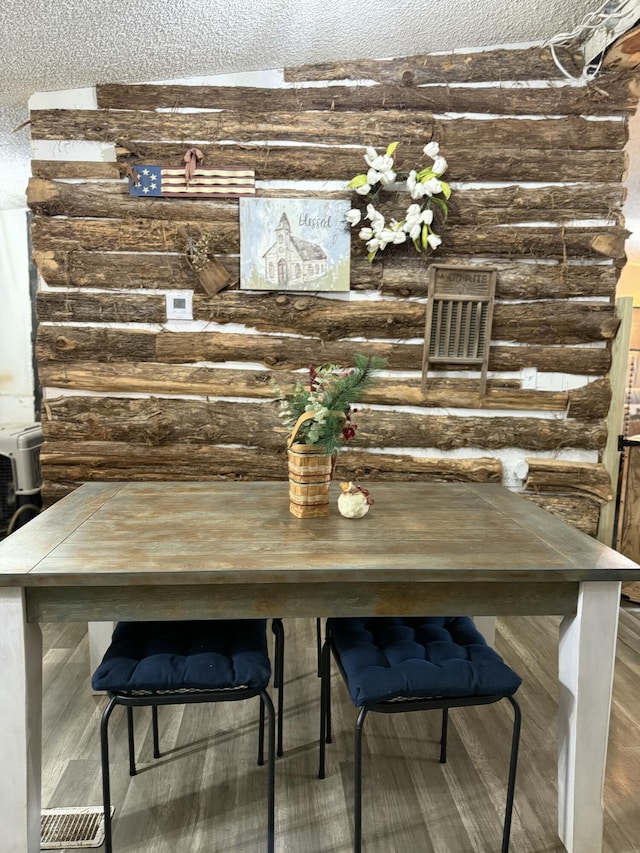 dining space featuring rustic walls