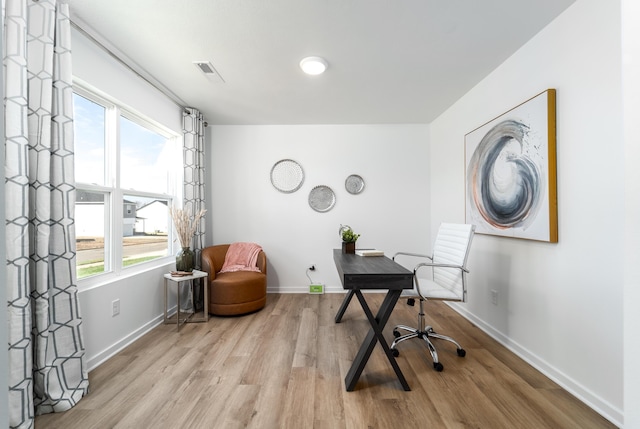 office area with a healthy amount of sunlight and light hardwood / wood-style floors