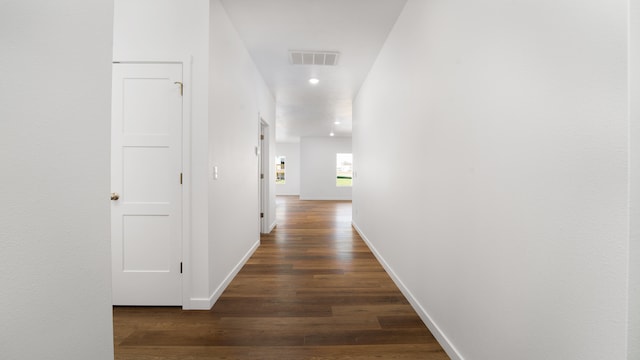 hall with dark hardwood / wood-style flooring