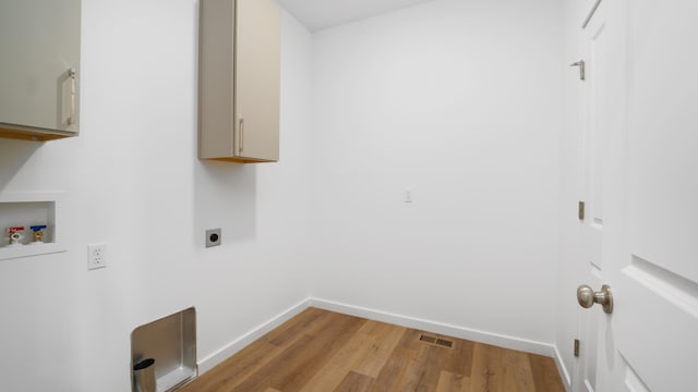 laundry room with cabinets, hookup for a washing machine, light wood-type flooring, and hookup for an electric dryer