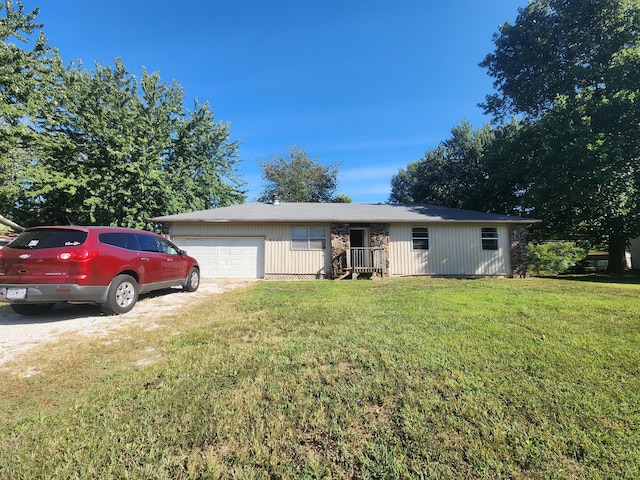 single story home with a garage and a front yard