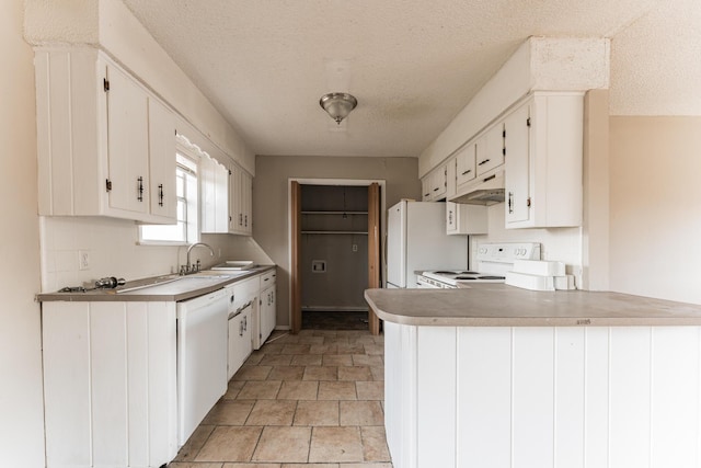 kitchen featuring white cabinets, white appliances, and kitchen peninsula