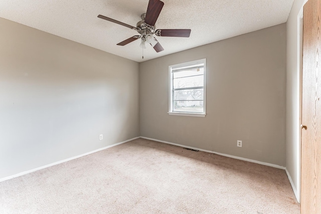 unfurnished room featuring carpet, ceiling fan, and a textured ceiling