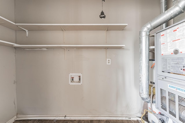 clothes washing area featuring hookup for a washing machine and heating unit