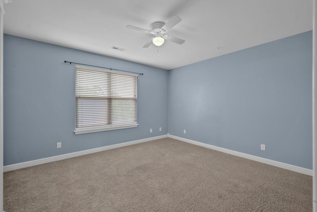 spare room featuring carpet floors and ceiling fan