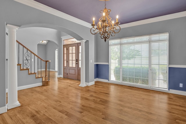 interior space featuring crown molding, plenty of natural light, a chandelier, and light hardwood / wood-style flooring