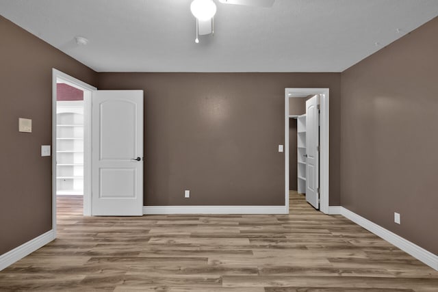 spare room with light hardwood / wood-style flooring and ceiling fan