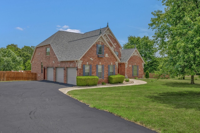 view of front of home with a garage and a front yard