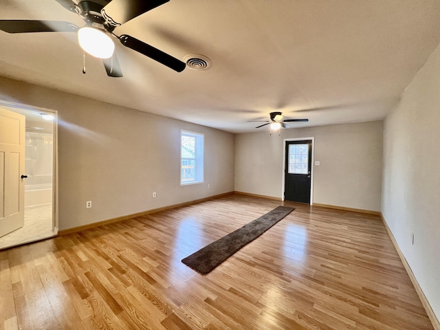 spare room featuring ceiling fan and light hardwood / wood-style floors