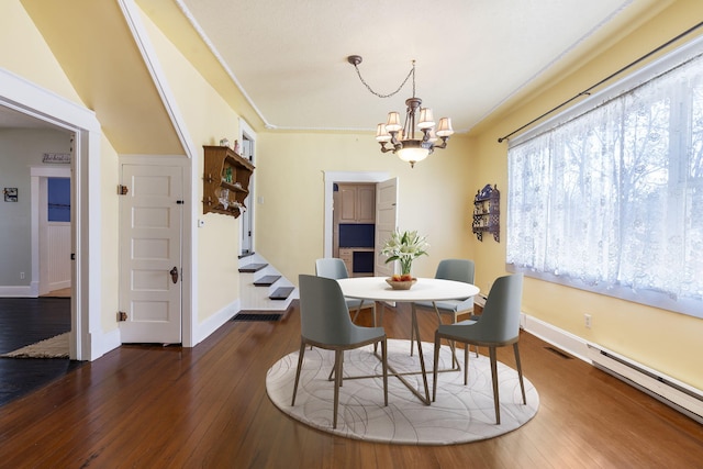 dining room featuring a notable chandelier, dark hardwood / wood-style floors, and a baseboard radiator