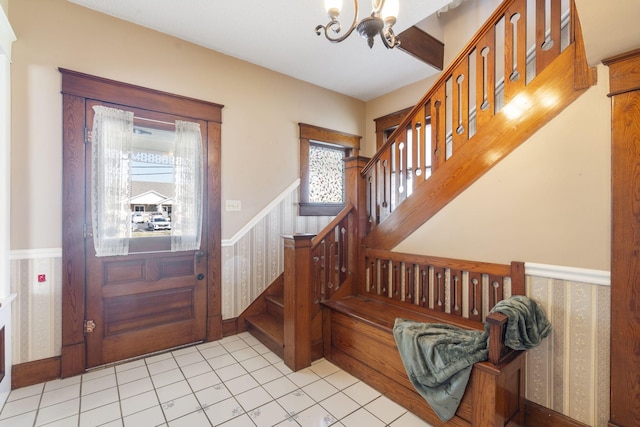 tiled foyer with a notable chandelier