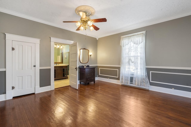 interior space featuring ceiling fan, crown molding, a textured ceiling, and hardwood / wood-style flooring