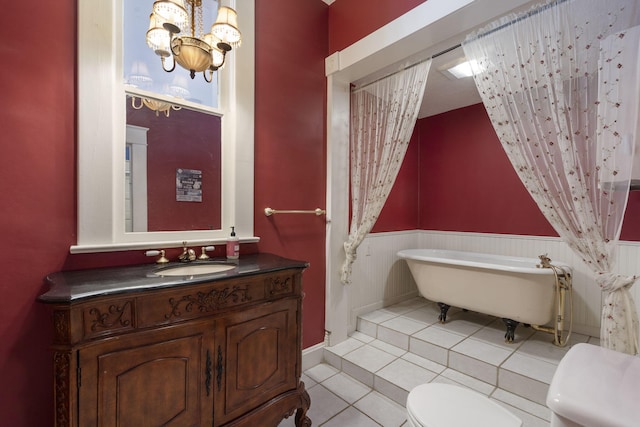 bathroom featuring a bathing tub, tile patterned flooring, a notable chandelier, toilet, and vanity