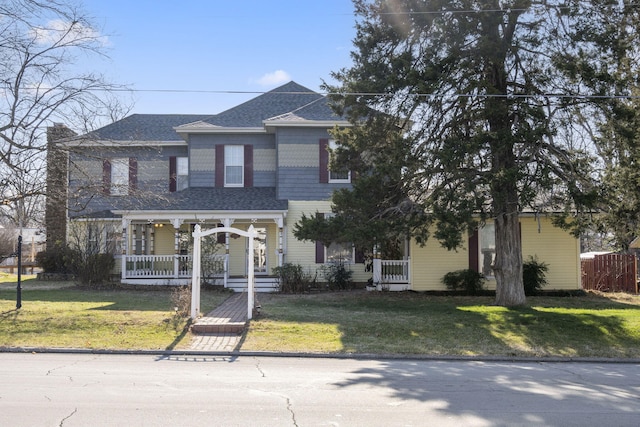 view of front of home with covered porch and a front yard