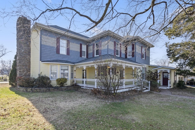 italianate house featuring a porch and a front lawn