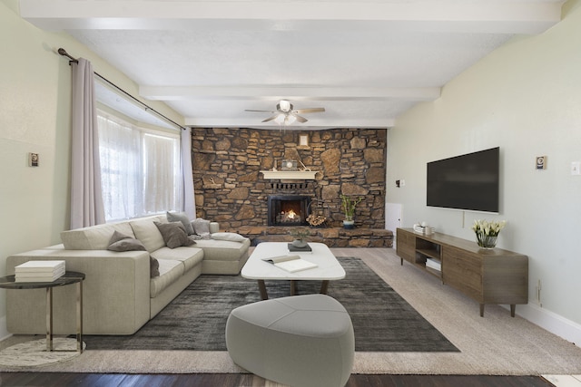 living room with a fireplace, beam ceiling, dark hardwood / wood-style floors, and ceiling fan