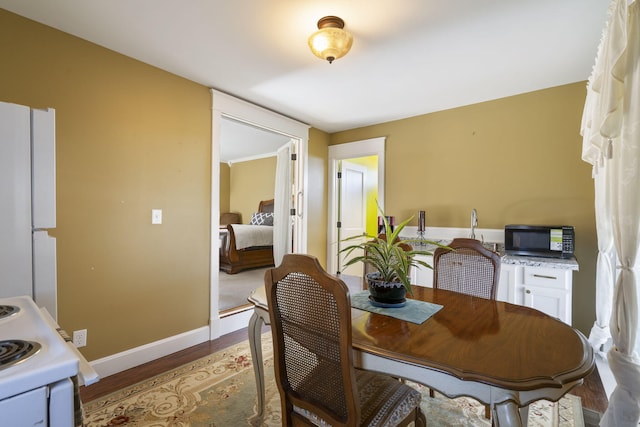 dining space with hardwood / wood-style flooring