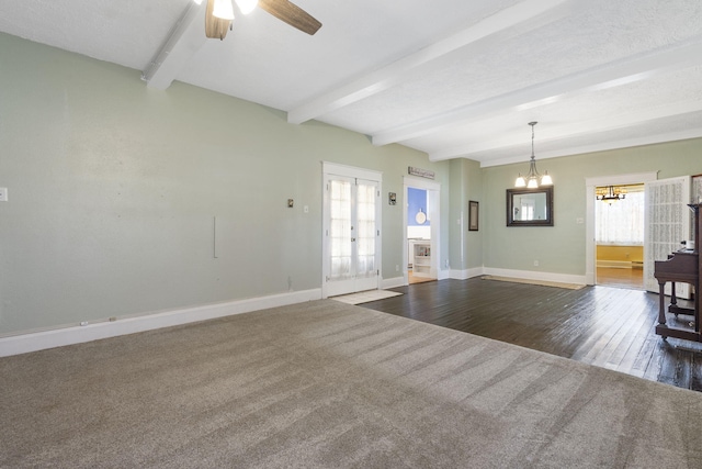 unfurnished living room with ceiling fan with notable chandelier, beam ceiling, and a textured ceiling