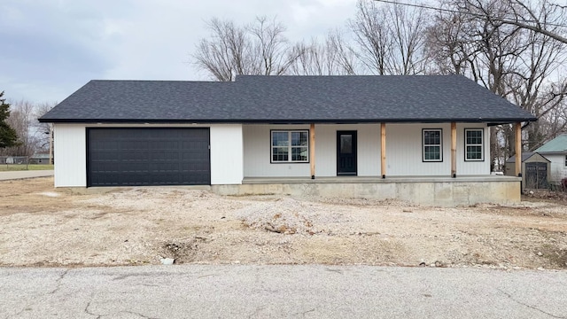 view of front of house featuring a porch and a garage