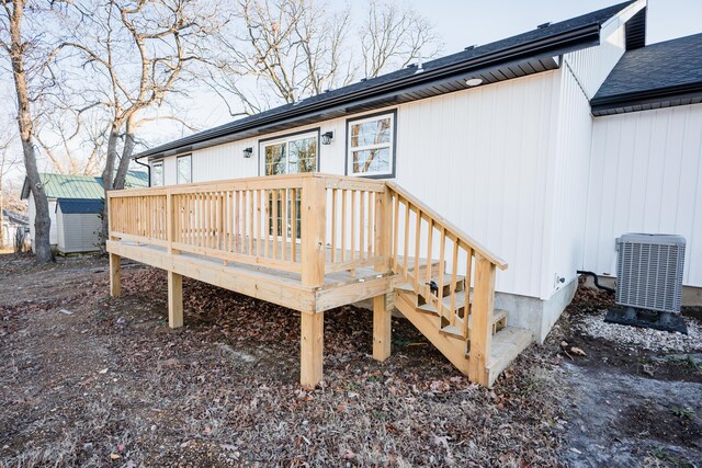 wooden deck featuring cooling unit