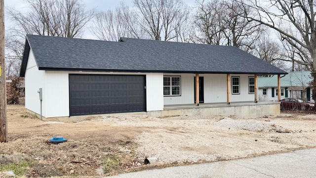 view of front of home featuring covered porch and a garage