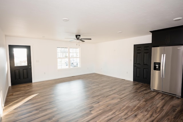 unfurnished living room featuring dark hardwood / wood-style floors and ceiling fan