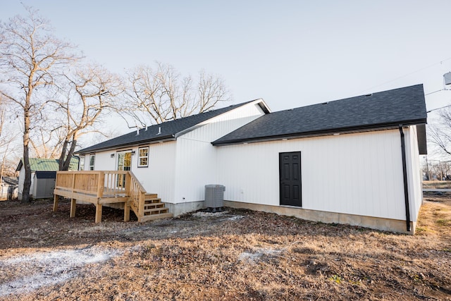 rear view of house featuring central AC unit and a deck