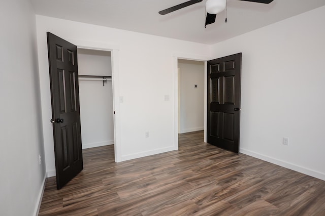 unfurnished bedroom with a closet, ceiling fan, and dark wood-type flooring