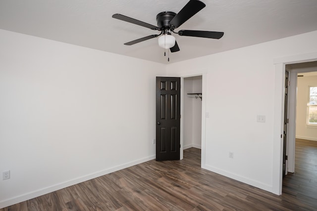 unfurnished bedroom with a closet, ceiling fan, and dark hardwood / wood-style floors