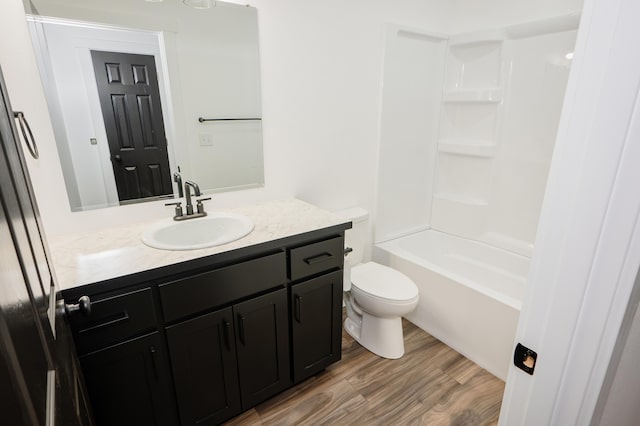 full bathroom featuring vanity, hardwood / wood-style flooring, toilet, and shower / bathtub combination