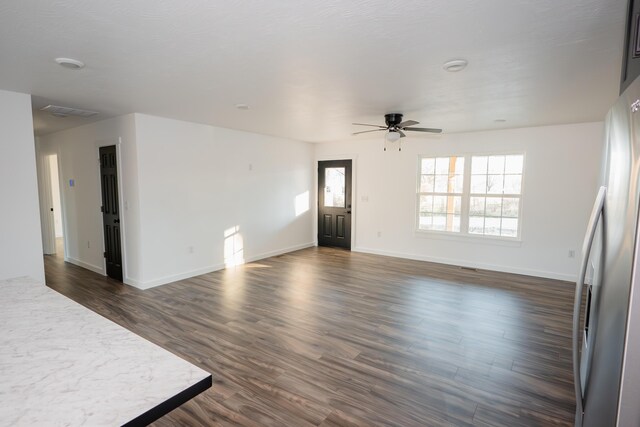 unfurnished room featuring ceiling fan and dark wood-type flooring