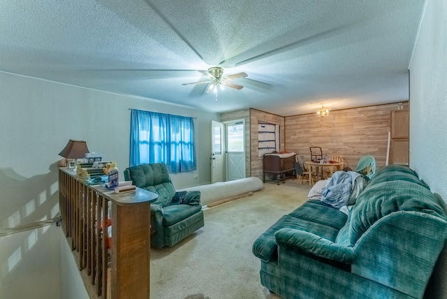 living room featuring a textured ceiling, carpet floors, ceiling fan, and wood walls