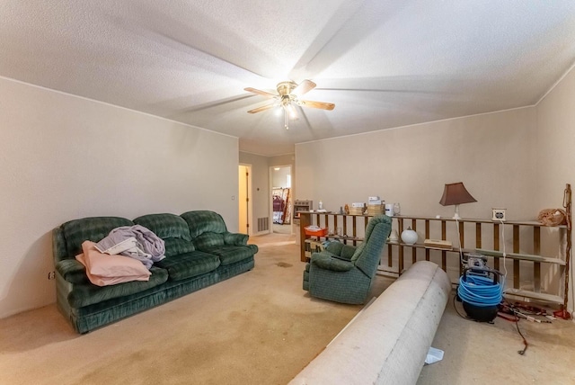 carpeted living room with a textured ceiling and ceiling fan