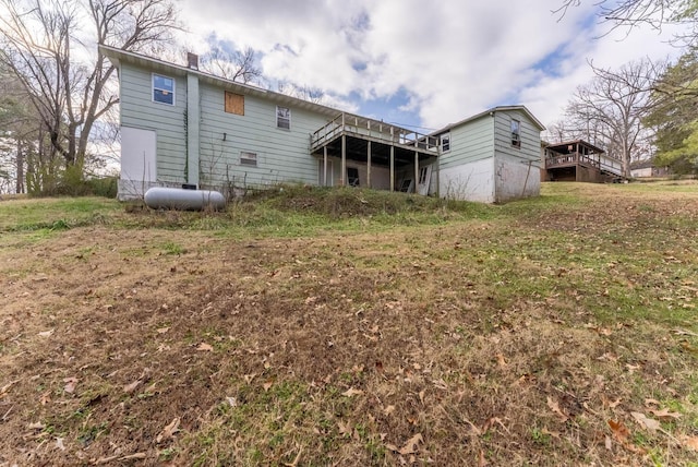 rear view of house featuring a wooden deck