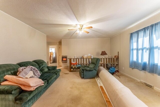 living room featuring carpet flooring, ceiling fan, and heating unit