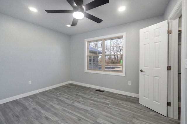 spare room with wood-type flooring and ceiling fan