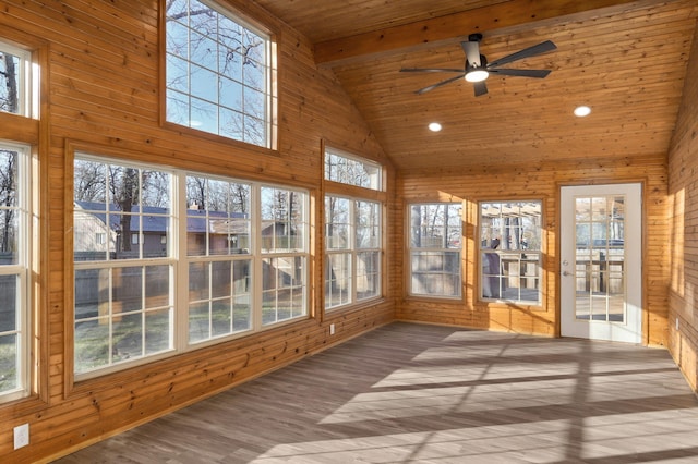 unfurnished sunroom featuring ceiling fan, plenty of natural light, lofted ceiling with beams, and wooden ceiling