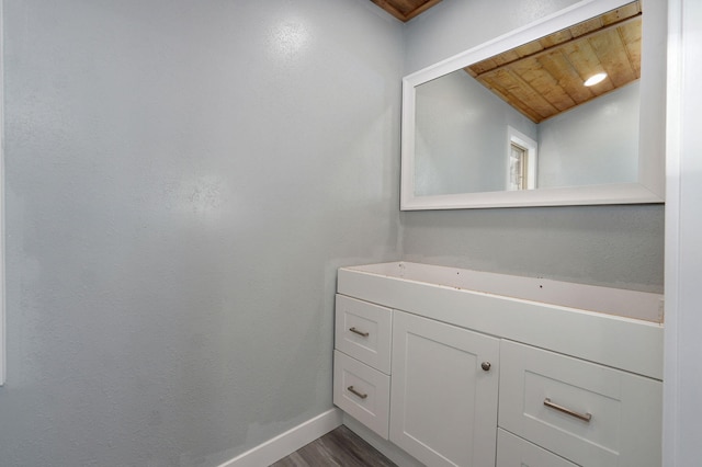 bathroom featuring wood-type flooring and wood ceiling