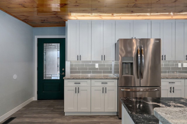 kitchen featuring light stone counters, dark hardwood / wood-style flooring, white cabinets, and stainless steel refrigerator with ice dispenser