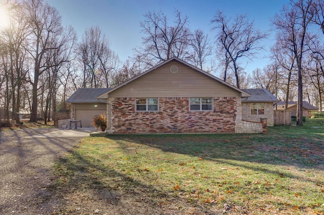 view of side of home featuring a garage and a yard